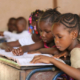 Image: Girls in a school in Africa studying out of textbooks