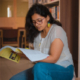 Image: Indian woman looking at textbook in a library