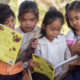 Image: Girls in the Philippines sitting outside story books