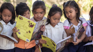 Image: Girls in the Philippines sitting outside story books